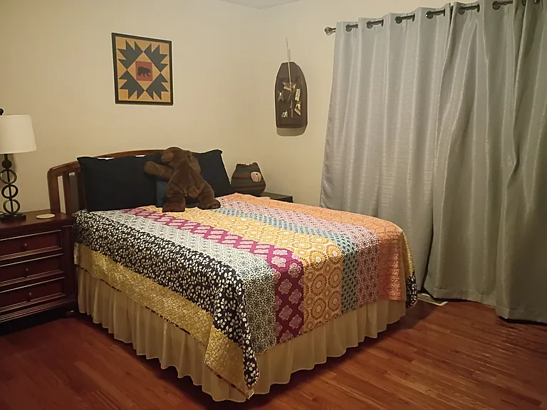 The third bedroom, known as the "Bear Room," features a queen-size bed and a chest of drawers.