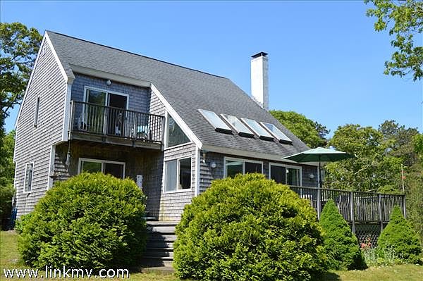 Rear of home with decks overlooking private yard