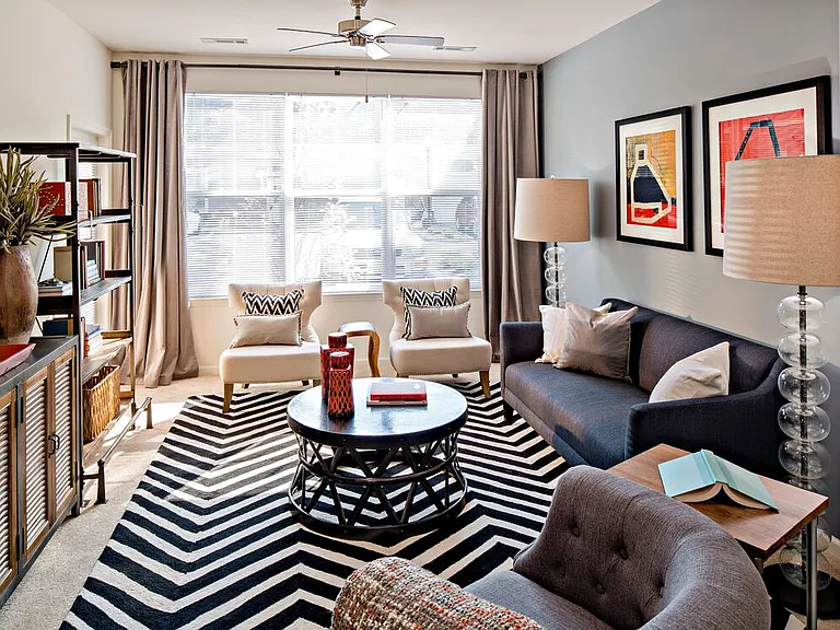 Living room with carpet (select homes)