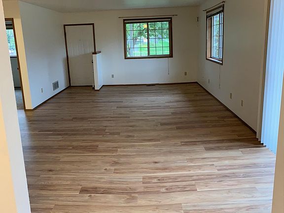 Light and bright living room with newer luxury plank flooring and sliding door to large deck!