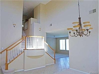 Elegant dual staircase to second floor is an eye-catching fe