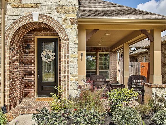You'll appreciate the architectural detail of the arched entry that leads you to the charming porch area!
