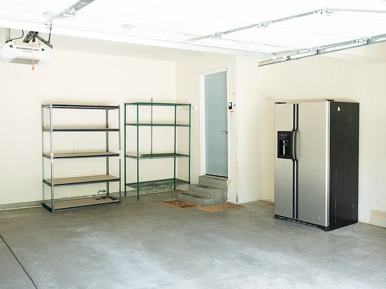 Garage, including storage shelves and extra fridge/freezer