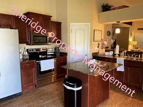 Gorgeous cherry cabinets and large kitchen and kitchenette area