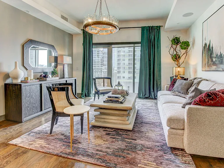 Sizable Living Room with Hardwood Style Flooring, Solar Shades, and Natural Lighting