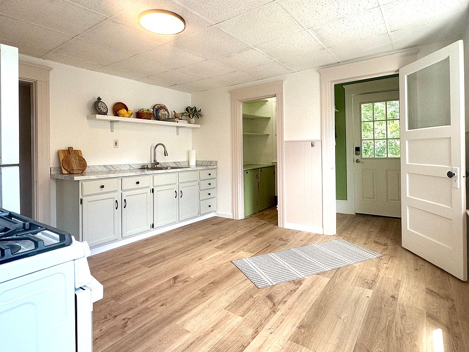 Kitchen with view of pantry and mudroom entrance.