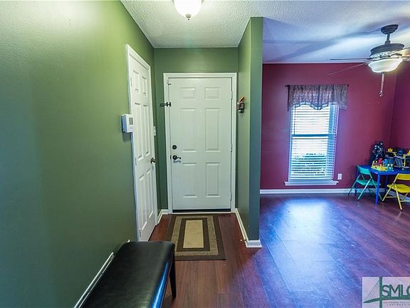 Foyer entrance opens to  dining room(used as play room) and living room