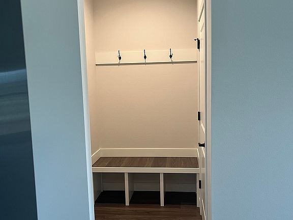 entryway bench/coat closet (closet door on right)