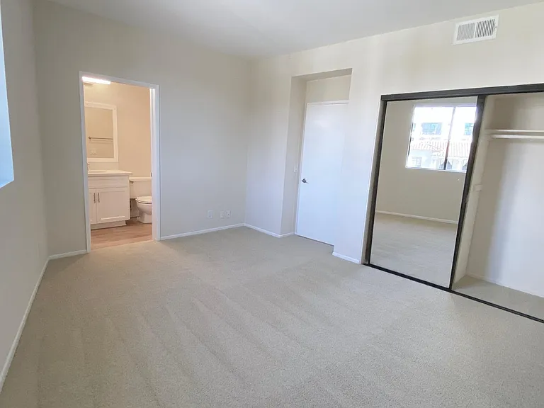Primary bedroom of apartment #201