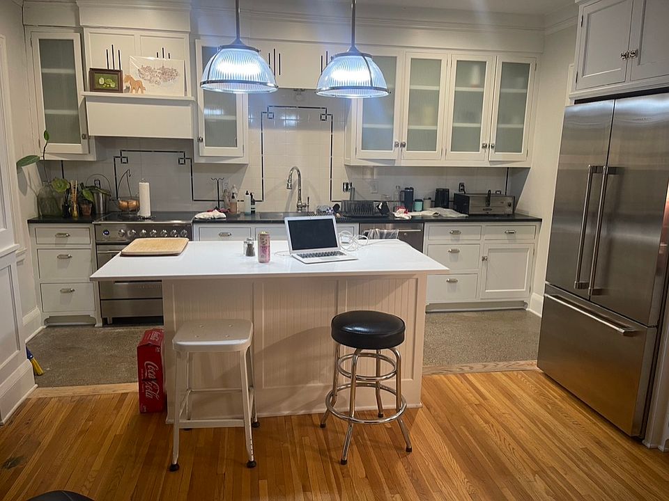 Full view of the completely rebuilt/restored kitchen with new appliances, countertops, cabinets and restored polished concrete floor.