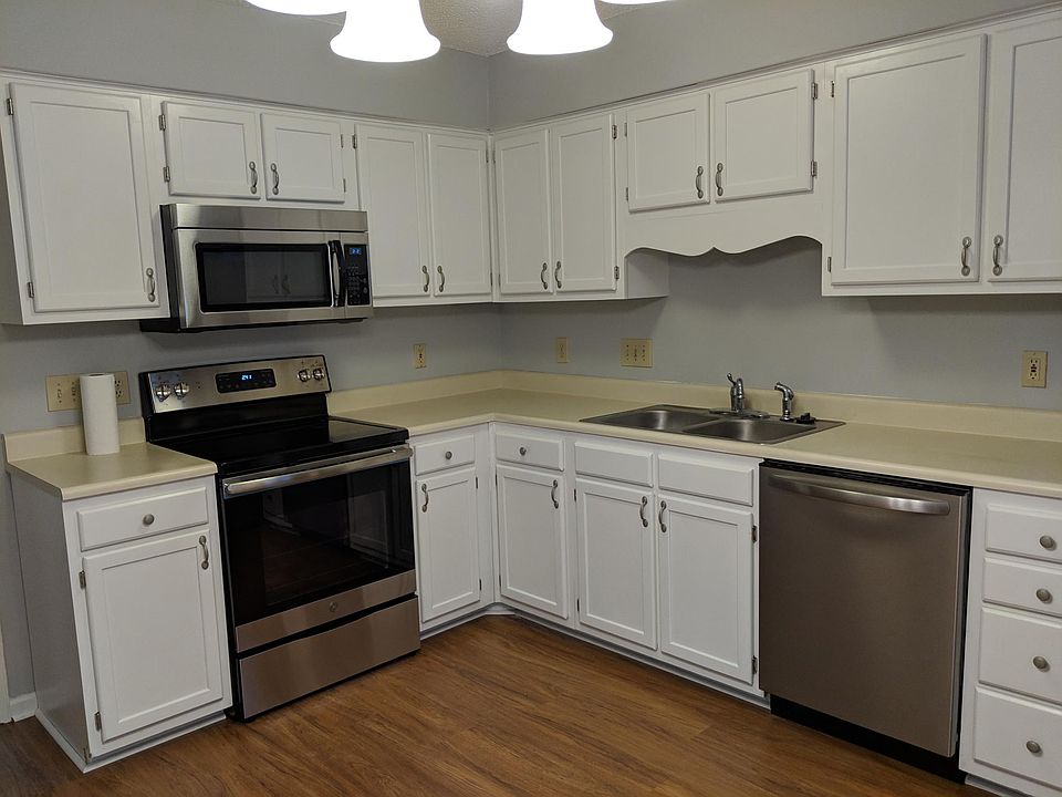 Large eat-in kitchen with freshly painted cabinets, all new hardware, light fixtures and stainless steel appliances.