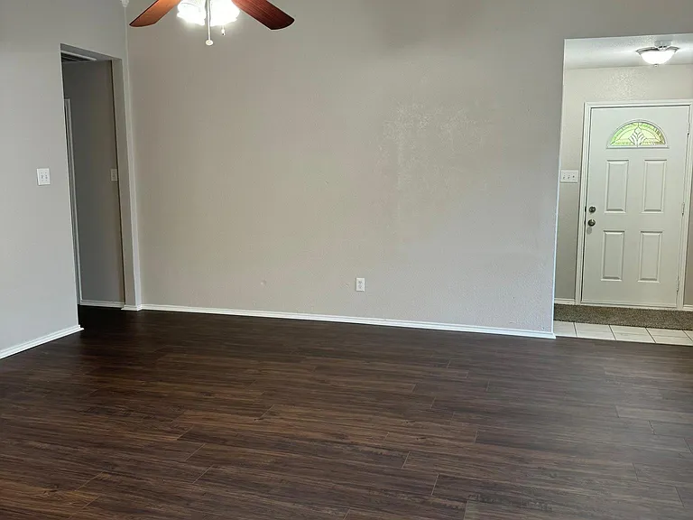 Open floorplan. Living room from kitchen looking out to front door. Left is hallway to the other bedrooms and 2nd bath.