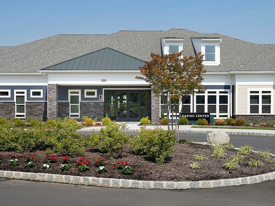 Inviting leasing center exterior with modern architecture and lush landscaped gardens.