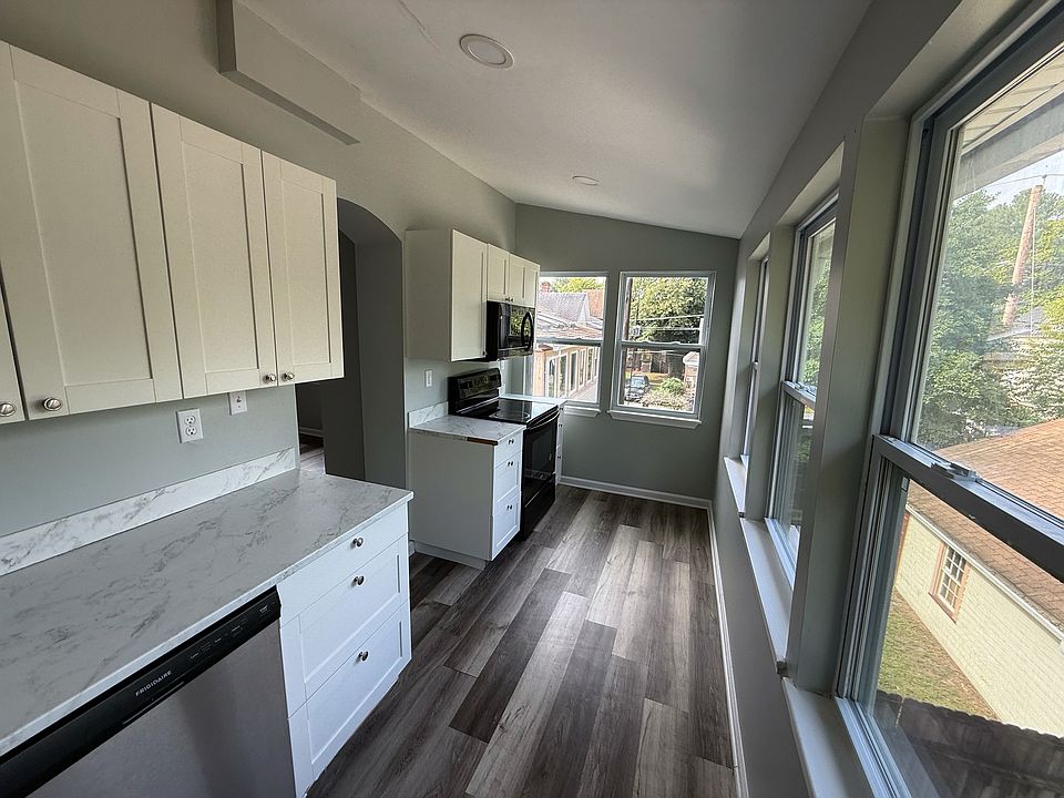 Kitchen equipped with fridge, dishwasher, microwave, and stove.
