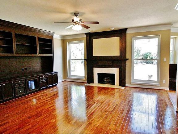 Crown molding embellishes Living Room that features built-in cabinets