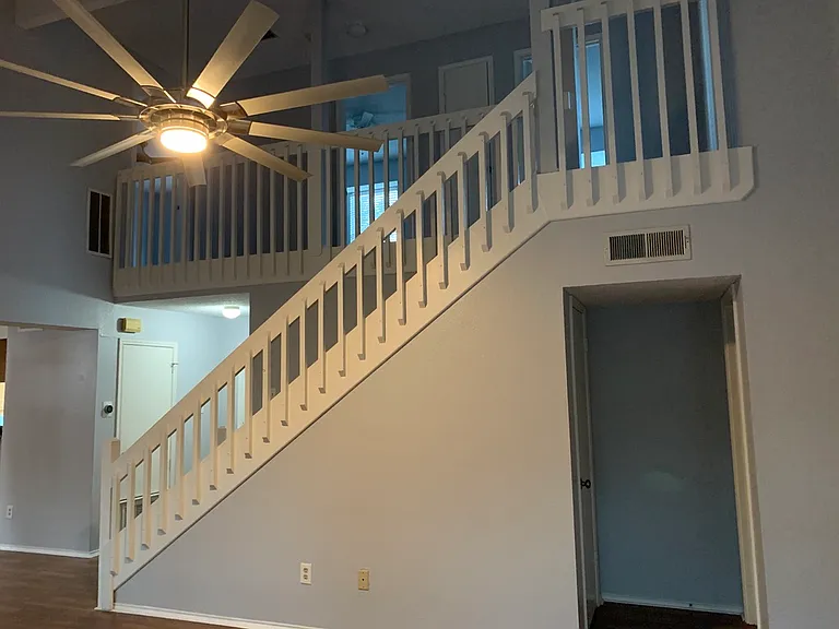 Stairs to the upstairs bedrooms and bathrooms, doorway goes to a closet and half bath.