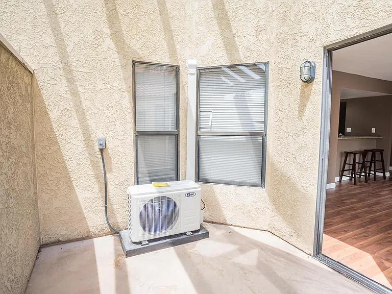 Patio space with AC unit vent outside.