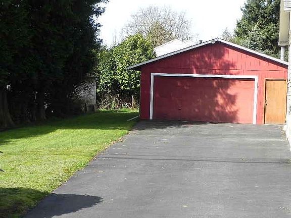Long, level driveway leads to 2-car detached garage/shop.