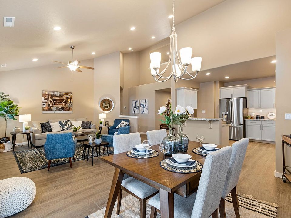 Chef's kitchen with granite countertops, stainless appliances, and a seamless open-concept flow to the dining and living areas.