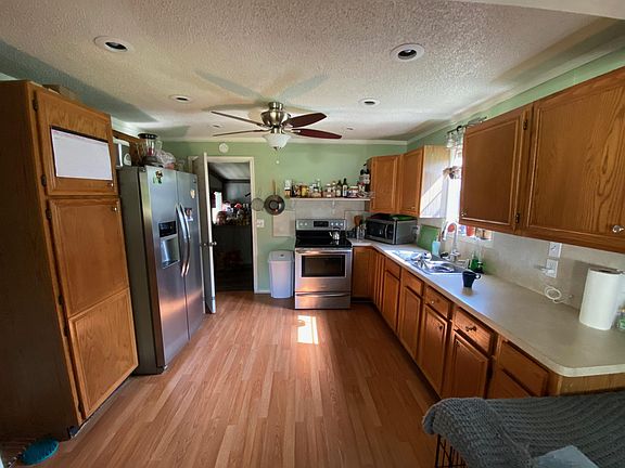 Kitchen with stainless fridge, oven, & microwave