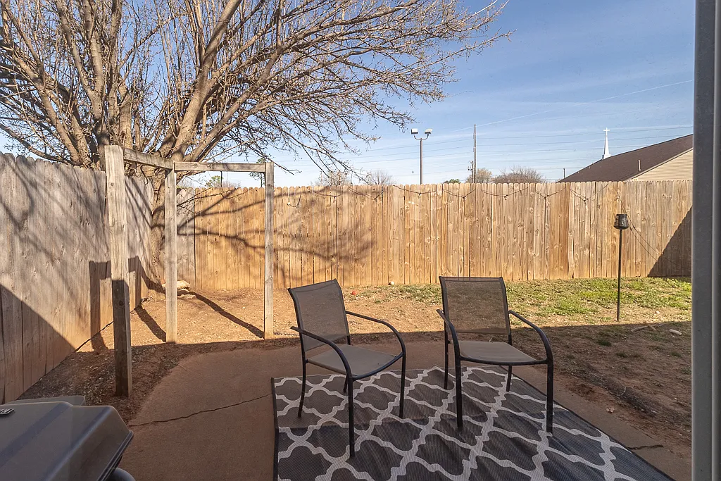 Outdoor patio area. New concrete patio no pathway being installed 6/15/26. New fence with gate on side of unit - 501 Wild Wind Rd