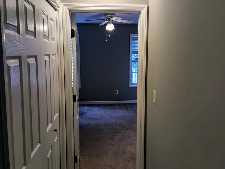 Hallway between bed rooms showing laundry closet