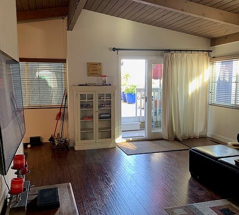 From hall looking to front entrance slider through living area