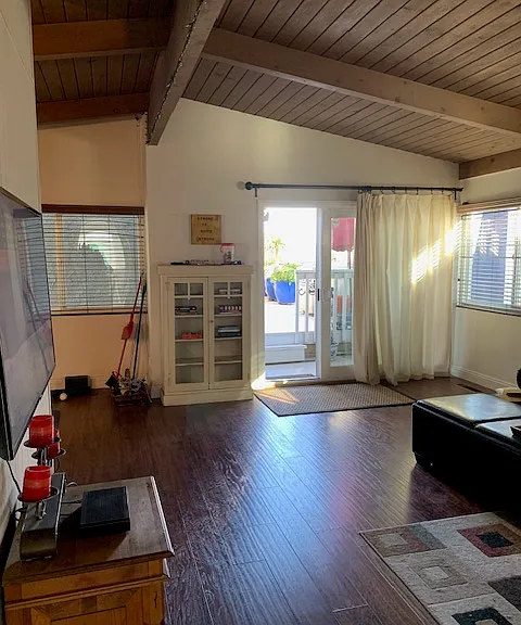 From hall looking to front entrance slider through living area