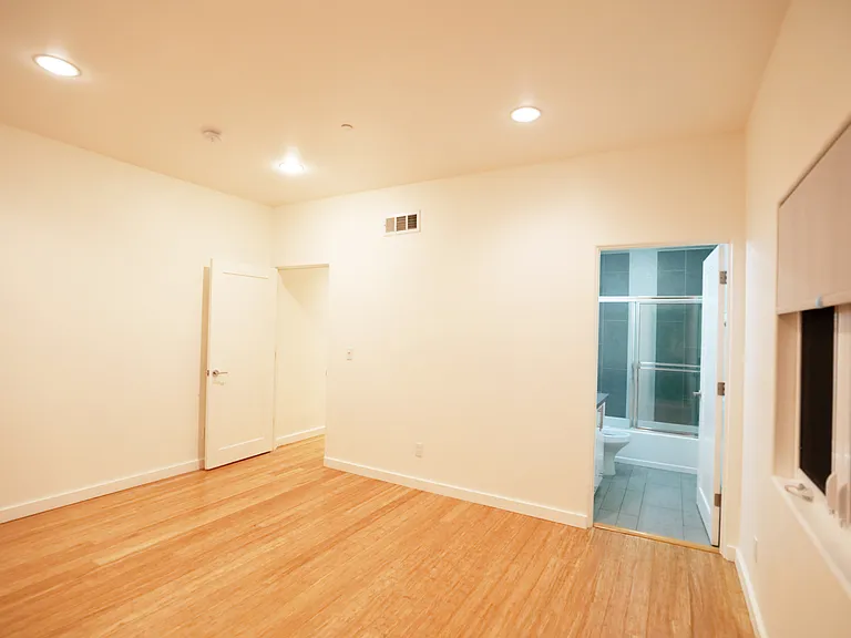32. Rear Bedroom Bathroom and Entry Doors looking East