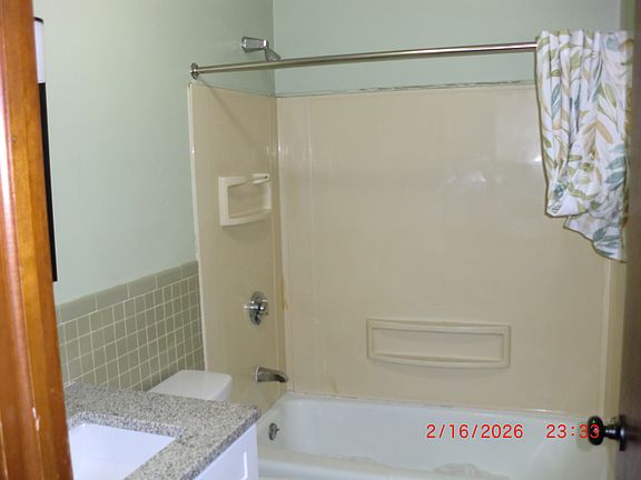 one bathroom with tub and shower