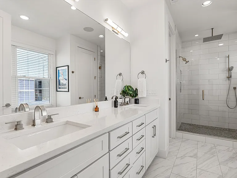 Primary bath featuring dual vanity and contemporary finishes.