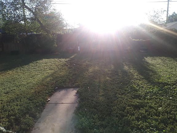 Lots of space to play and garden in the fully enclosed back yard with a 6 ft. Wooden fence