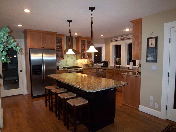 spacious kitchen with granite counters, desk area, stainless steel appliances 