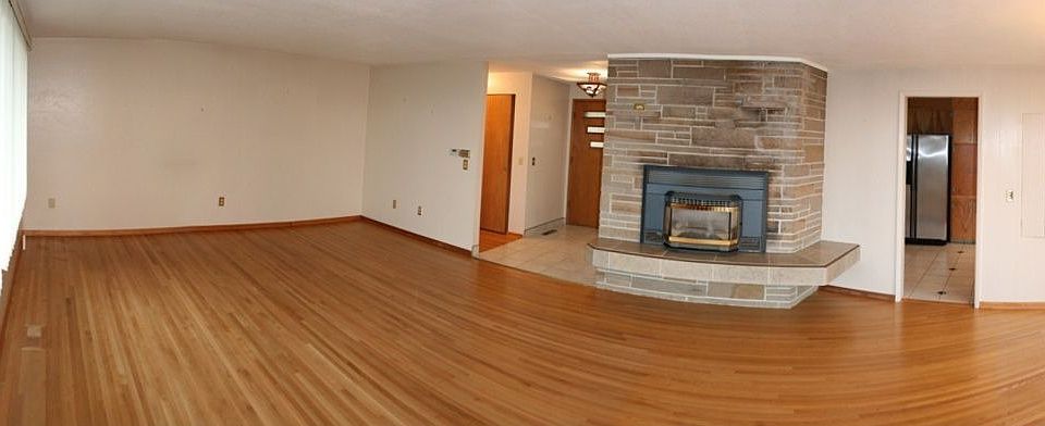 Fireplace and wood floor in living room.