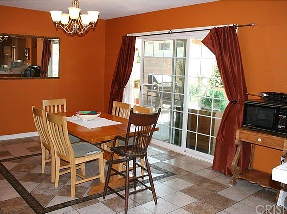 Dining Room open to kitchen and family/living room with custom tile flooring.