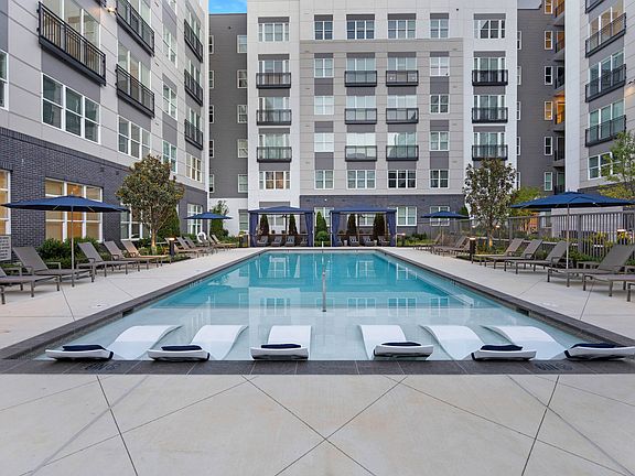 Resort-style pool courtyard with sun shelf seating