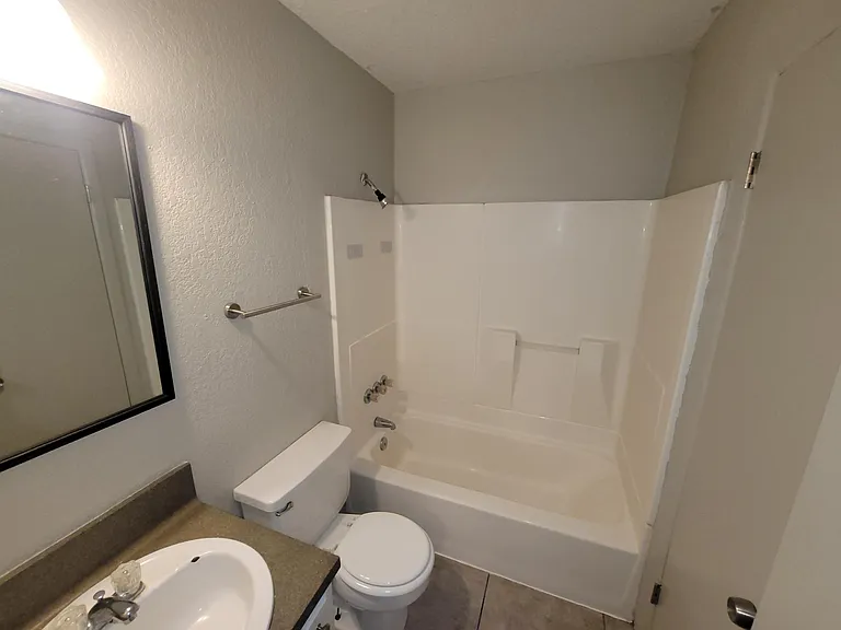 Bathroom with updated fixtures and hardware, and a linen closet.