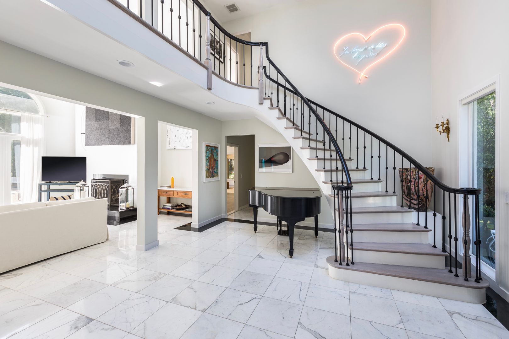  Light-filled foyer outfitted with marble floors, 20ft ceilings. 