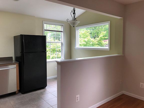 Bright kitchen surrounded by trees with room for nook/table.