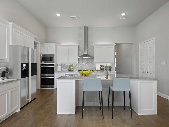 Kitchen in the Renoir home plan by Trophy Signature Homes - REPRESENTATIVE PHOTO