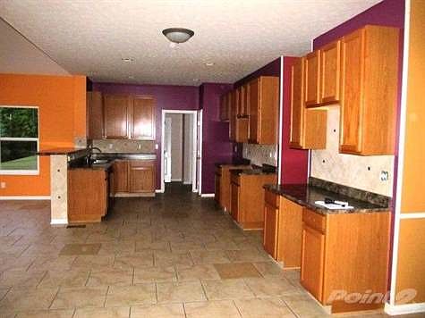 The kitchen features 42 inch wood cabinets, tile backsplash, tile flooring, pantry, recessed lightin
