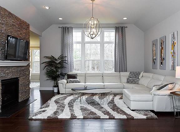 Living Room, or Gathering Room as Pulte Homes references the room, with see thru Gas Fireplace and b