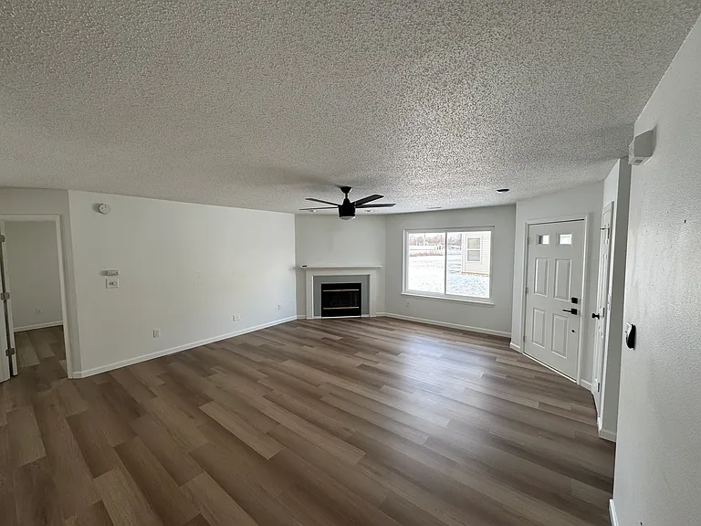 Bright living room with luxury vinyl plank flooring and an open layout.