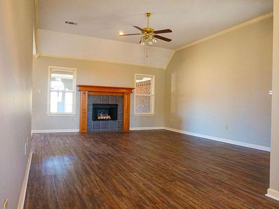 Beautiful living room with gas fireplace, high ceilings, and new laminate floors.