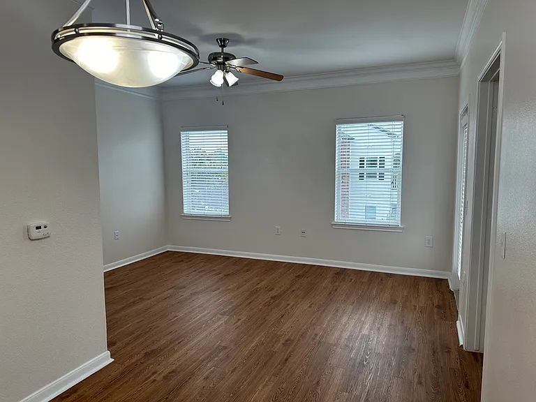 Bright and inviting room with elegant wood-style floors and modern ceiling fan, perfect for a cozy living space. Bright and inviting room with elegant wood-style floors and modern ceiling fan, perfect for a cozy living space.