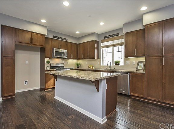 Gorgeous kitchen features granite counter tops, subway tile backsplash