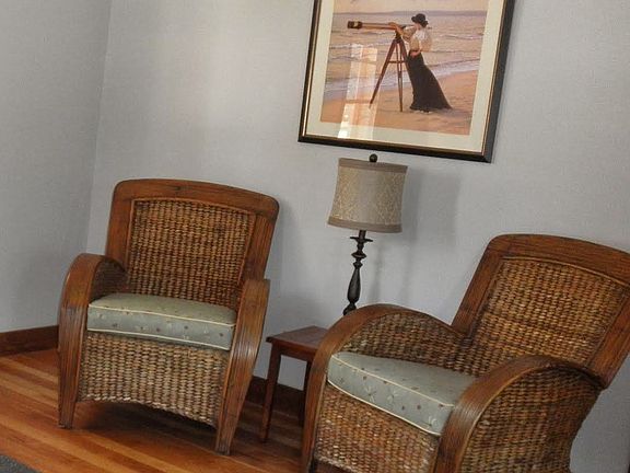 Additional seating in living room. There's actually a smart TV on that wall now.