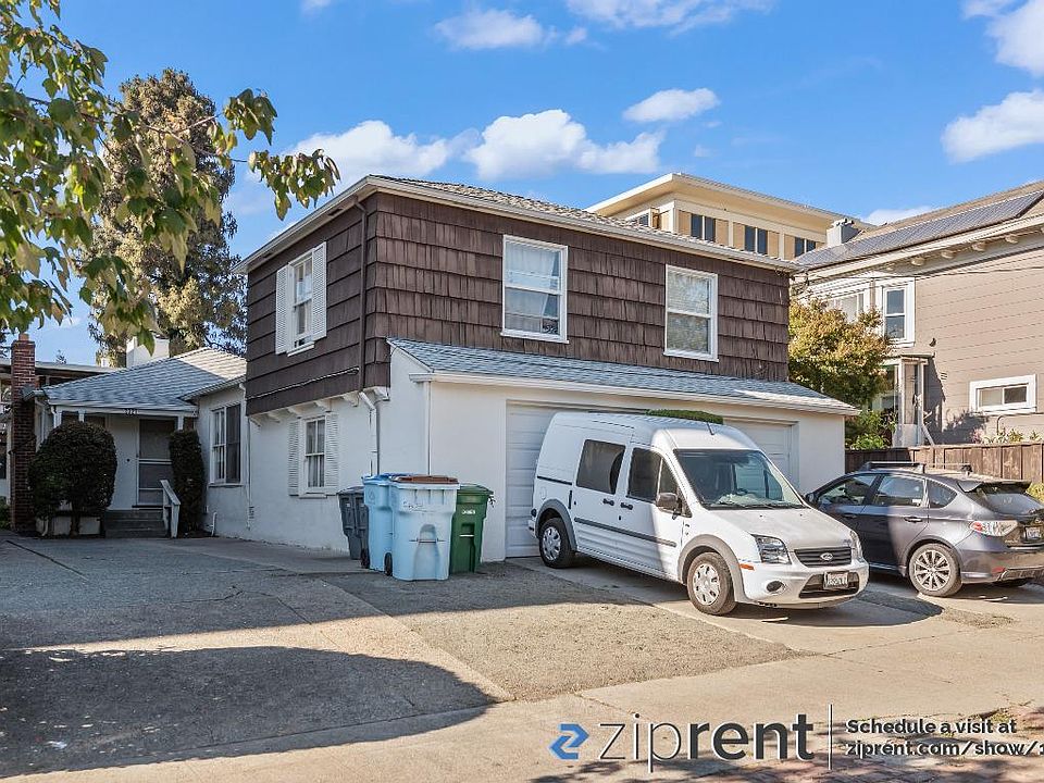 Front of property, showing the driveway on left with parking for tenants.