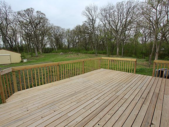 Large deck with two stairs. Barn in back ground. Fire pit and walking paths. Pleasant Valley F.P. Walking distance