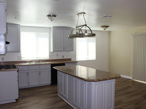 Remodeled kitchen w/granite counter tops and new laminate flooring . New stove, sink and dishwasher.